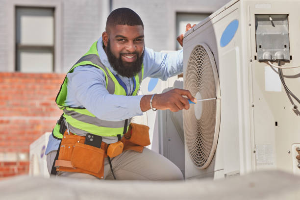 African technician servicing an air conditioning unit